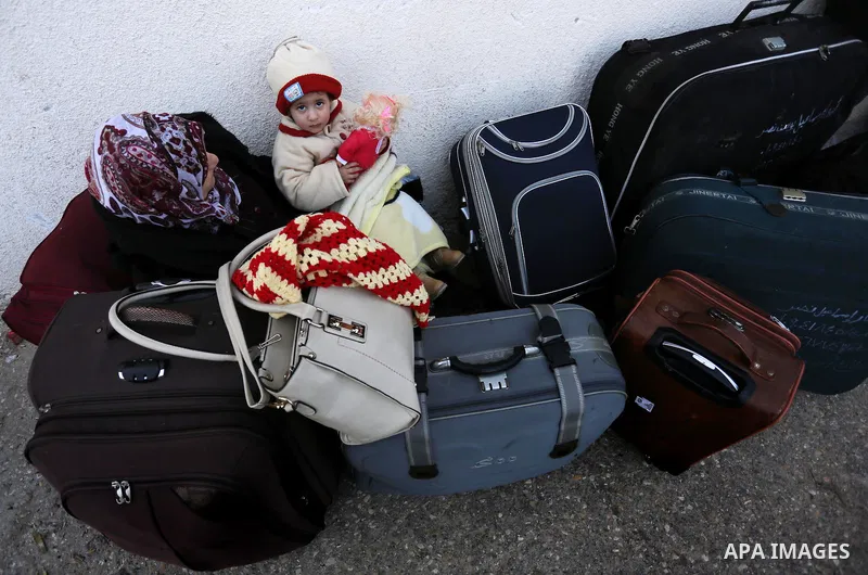 Palestinians wait for travel permits to cross into Egypt through the Rafah border crossing after it was opened by Egyptian authorities for humanitarian cases, in Rafah in the southern Gaza Strip on February 11, 2017. Pho...