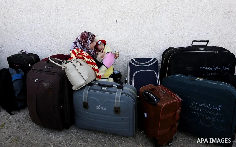 Palestinians wait for travel permits to cross into Egypt through the Rafah border crossing after it was opened by Egyptian authorities for humanitarian cases, in Rafah in the southern Gaza Strip on February 11, 2017. Pho...