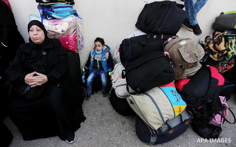 Palestinians wait for travel permits to cross into Egypt through the Rafah border crossing after it was opened by Egyptian authorities for humanitarian cases, in Rafah in the southern Gaza Strip on February 11, 2017. Pho...