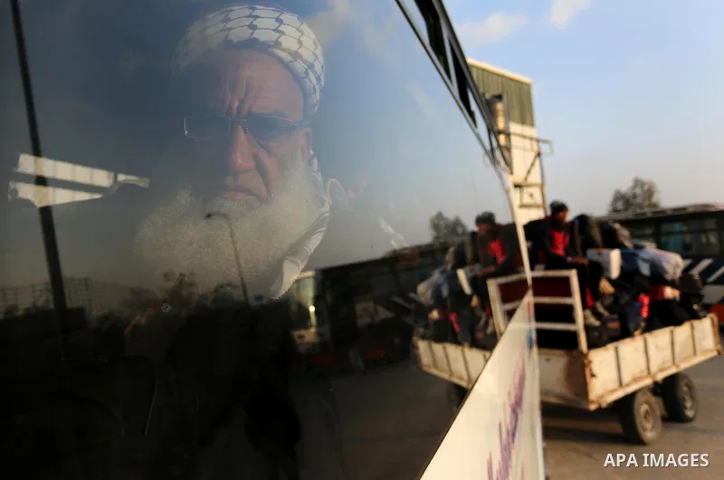 Palestinians sits in a bus as they wait for travel permits to cross into Egypt through the Rafah border crossing after it was opened by Egyptian authorities for humanitarian cases, in Rafah in the southern Gaza Strip on...