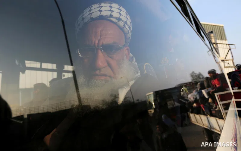 Palestinians sits in a bus as they wait for travel permits to cross into Egypt through the Rafah border crossing after it was opened by Egyptian authorities for humanitarian cases, in Rafah in the southern Gaza Strip on...