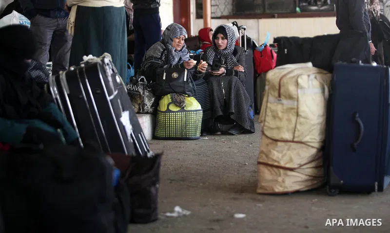Palestinians wait for travel permits to cross into Egypt through the Rafah border crossing after it was opened by Egyptian authorities for humanitarian cases, in Rafah in the southern Gaza Strip on February 11, 2017. Pho...