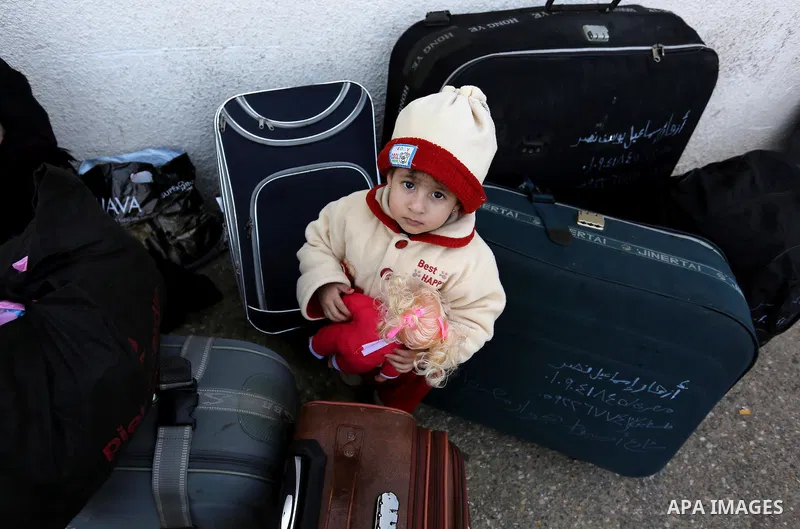 Palestinians wait for travel permits to cross into Egypt through the Rafah border crossing after it was opened by Egyptian authorities for humanitarian cases, in Rafah in the southern Gaza Strip on February 11, 2017. Pho...