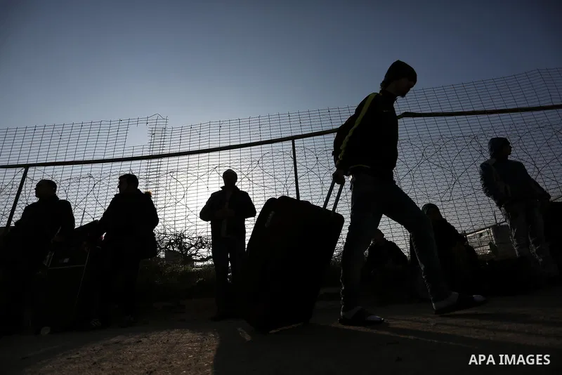 Palestinians wait for travel permits to cross into Egypt through the Rafah border crossing after it was opened by Egyptian authorities for humanitarian cases, in Rafah in the southern Gaza Strip on February 11, 2017. Pho...