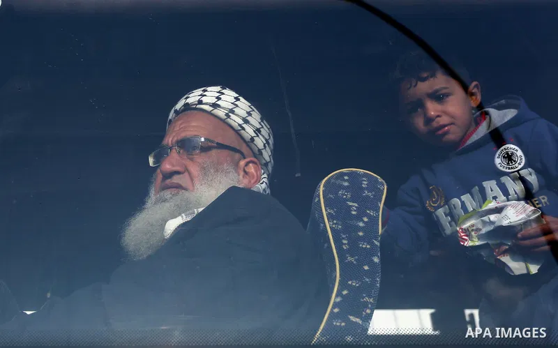 Palestinians sits in a bus as they wait for travel permits to cross into Egypt through the Rafah border crossing after it was opened by Egyptian authorities for humanitarian cases, in Rafah in the southern Gaza Strip on...
