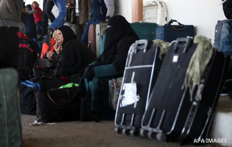 Palestinians wait for travel permits to cross into Egypt through the Rafah border crossing after it was opened by Egyptian authorities for humanitarian cases, in Rafah in the southern Gaza Strip on February 11, 2017. Pho...