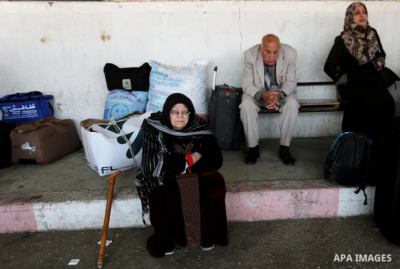 Palestinians wait for travel permits to cross into Egypt through the Rafah border crossing after it was opened by Egyptian authorities for humanitarian cases, in Rafah in the southern Gaza Strip on February 11, 2017. Pho...