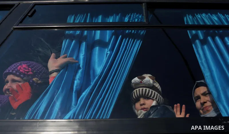 Palestinians sit in a bus as they wait for travel permits to cross into Egypt through the Rafah border crossing after it was opened by Egyptian authorities for humanitarian cases, in Rafah in the southern Gaza Strip on F...
