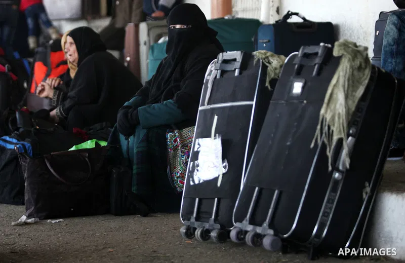 Palestinians wait for travel permits to cross into Egypt through the Rafah border crossing after it was opened by Egyptian authorities for humanitarian cases, in Rafah in the southern Gaza Strip on February 11, 2017. Pho...