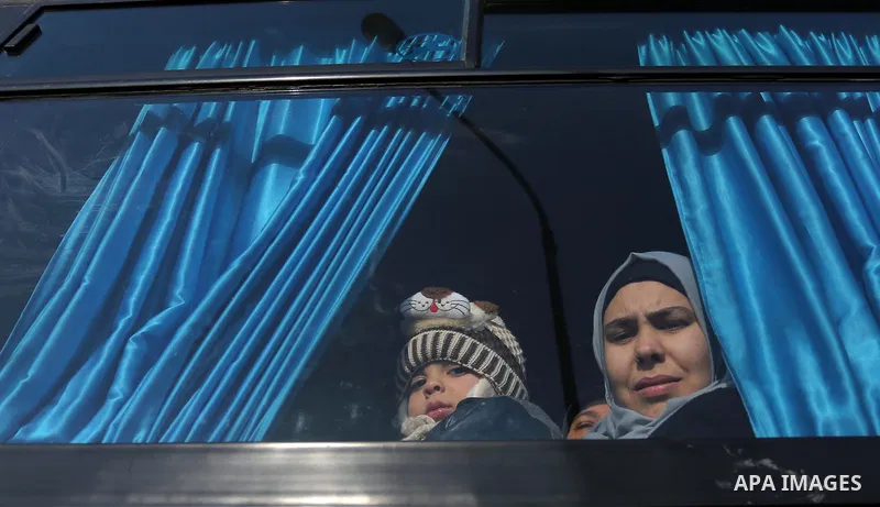 Palestinians sit in a bus as they wait for travel permits to cross into Egypt through the Rafah border crossing after it was opened by Egyptian authorities for humanitarian cases, in Rafah in the southern Gaza Strip on F...