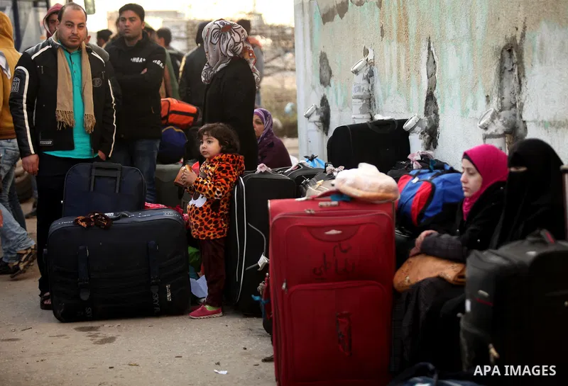 Palestinians wait for travel permits to cross into Egypt through the Rafah border crossing after it was opened by Egyptian authorities for humanitarian cases, in Rafah in the southern Gaza Strip on February 11, 2017. Pho...