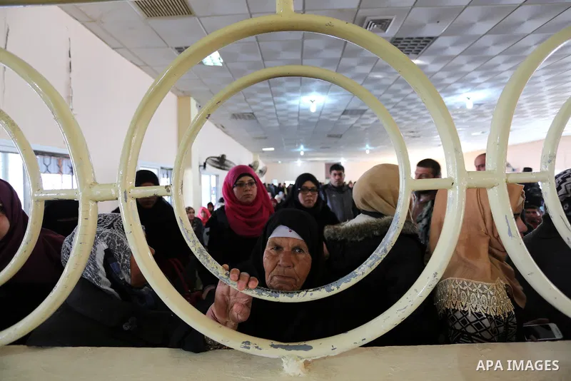 Palestinians wait for travel permits to cross into Egypt through the Rafah border crossing after it was opened by Egyptian authorities for humanitarian cases, in Rafah in the southern Gaza Strip on February 11, 2017. Pho...