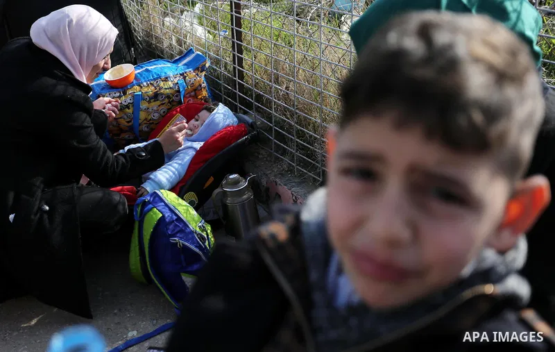 Palestinians wait for travel permits to cross into Egypt through the Rafah border crossing after it was opened by Egyptian authorities for humanitarian cases, in Rafah in the southern Gaza Strip on February 11, 2017. Pho...