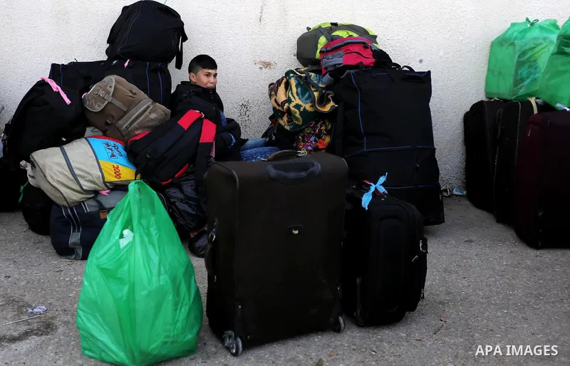 Palestinians wait for travel permits to cross into Egypt through the Rafah border crossing after it was opened by Egyptian authorities for humanitarian cases, in Rafah in the southern Gaza Strip on February 11, 2017. Pho...