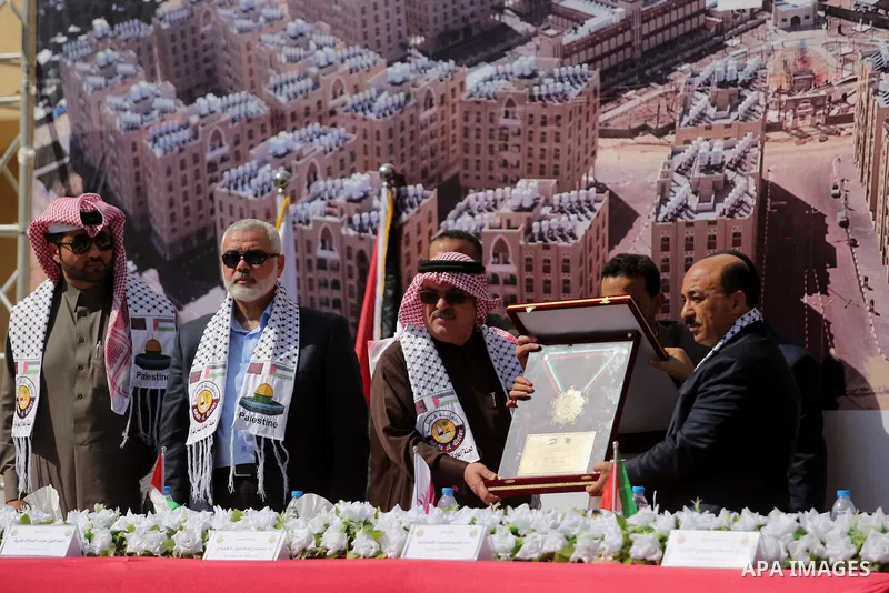 Hamas leader Ismail Haniyeh and Qatar's Ambassador to the Palestinian Authority, Mohammed Al Emadi attend the ceremony of the second phase of the Sheikh Hamad Town, in Khan Younis in the southern Gaza strip, on February...
