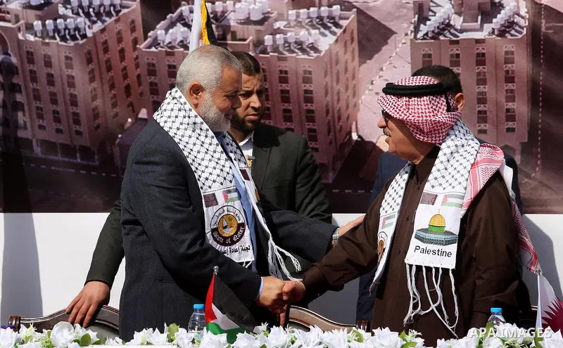 Hamas leader Ismail Haniyeh shakes hands with Qatar's Ambassador to the Palestinian Authority, Mohammed Al Emadi during the ceremony of the second phase of the Sheikh Hamad Town, in Khan Younis in the southern Gaza strip...