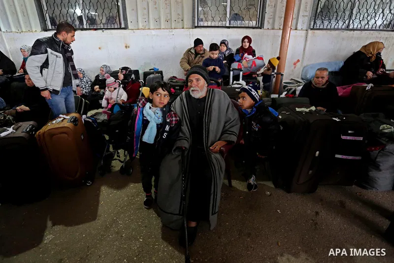 Palestinians wait for travel permits to cross into Egypt through the Rafah border crossing after it was opened by Egyptian authorities for humanitarian cases, in Rafah in the southern Gaza Strip on February 12, 2017. Pho...
