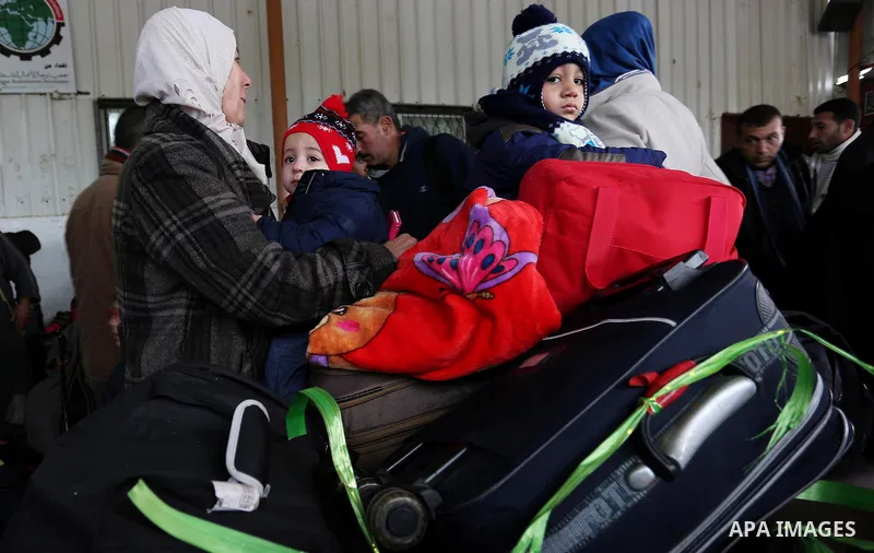 Palestinians wait for travel permits to cross into Egypt through the Rafah border crossing after it was opened by Egyptian authorities for humanitarian cases, in Rafah in the southern Gaza Strip on February 12, 2017. Pho...