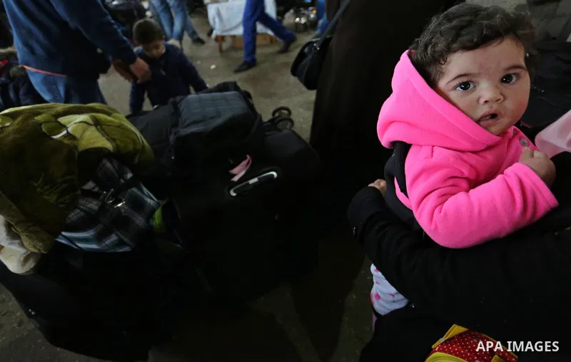 Palestinians wait for travel permits to cross into Egypt through the Rafah border crossing after it was opened by Egyptian authorities for humanitarian cases, in Rafah in the southern Gaza Strip on February 12, 2017. Pho...