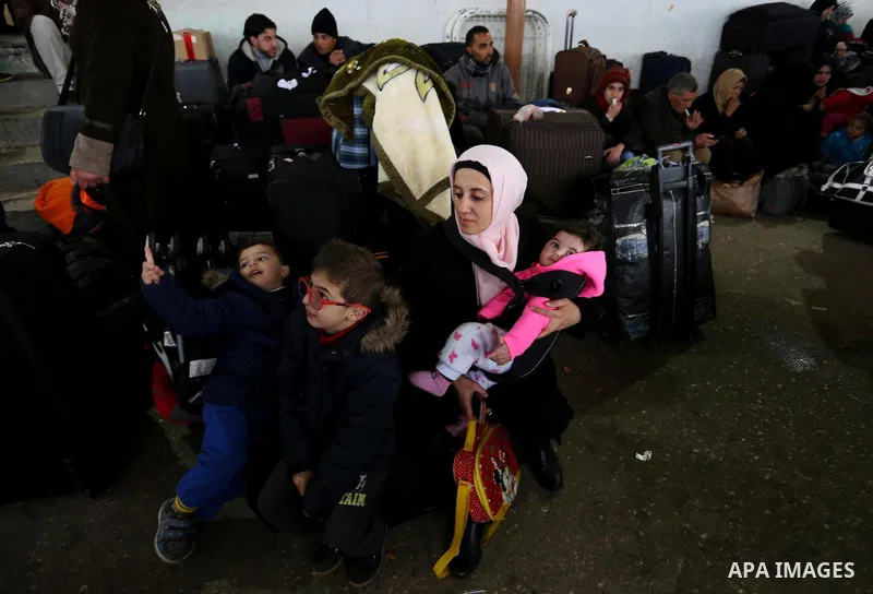 Palestinians wait for travel permits to cross into Egypt through the Rafah border crossing after it was opened by Egyptian authorities for humanitarian cases, in Rafah in the southern Gaza Strip on February 12, 2017. Pho...