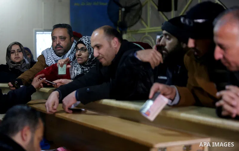Palestinians wait for travel permits to cross into Egypt through the Rafah border crossing after it was opened by Egyptian authorities for humanitarian cases, in Rafah in the southern Gaza Strip on February 12, 2017. Pho...