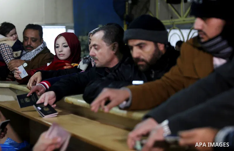 Palestinians wait for travel permits to cross into Egypt through the Rafah border crossing after it was opened by Egyptian authorities for humanitarian cases, in Rafah in the southern Gaza Strip on February 12, 2017. Pho...