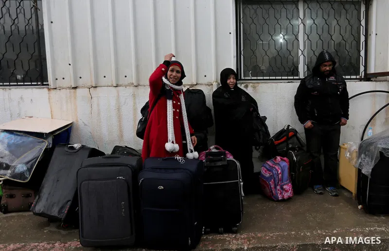 Palestinians wait for travel permits to cross into Egypt through the Rafah border crossing after it was opened by Egyptian authorities for humanitarian cases, in Rafah in the southern Gaza Strip on February 12, 2017. Pho...