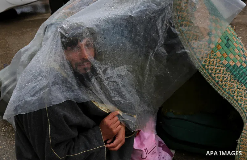 Palestinians wait for travel permits to cross into Egypt through the Rafah border crossing after it was opened by Egyptian authorities for humanitarian cases, in Rafah in the southern Gaza Strip on February 12, 2017. Pho...