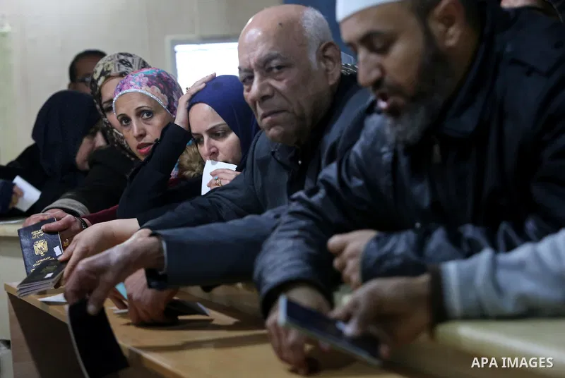Palestinians wait for travel permits to cross into Egypt through the Rafah border crossing after it was opened by Egyptian authorities for humanitarian cases, in Rafah in the southern Gaza Strip on February 12, 2017. Pho...