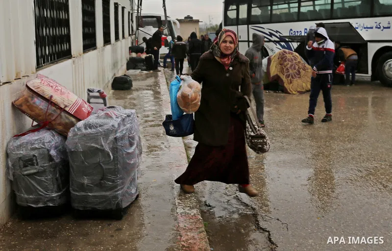 Palestinians wait for travel permits to cross into Egypt through the Rafah border crossing after it was opened by Egyptian authorities for humanitarian cases, in Rafah in the southern Gaza Strip on February 12, 2017. Pho...