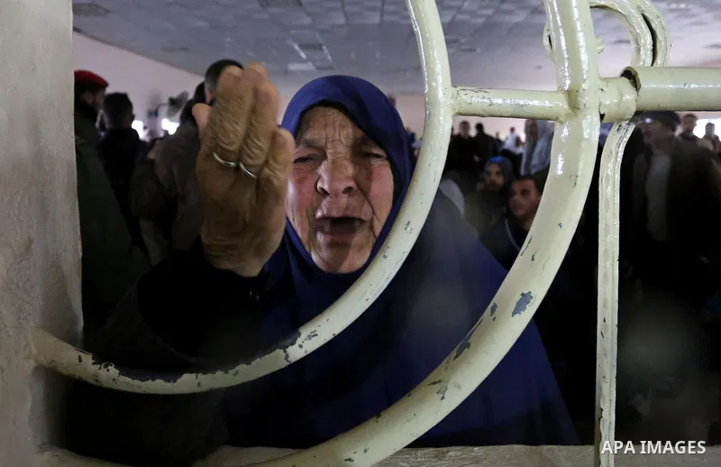 A Palestinian woman reacts as she asks for a travel permit to cross into Egypt through the Rafah border crossing, after it was opened by Egyptian authorities for humanitarian cases, in Rafah in the southern Gaza Strip on...