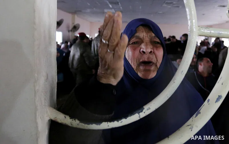A Palestinian woman reacts as she asks for a travel permit to cross into Egypt through the Rafah border crossing, after it was opened by Egyptian authorities for humanitarian cases, in Rafah in the southern Gaza Strip on...