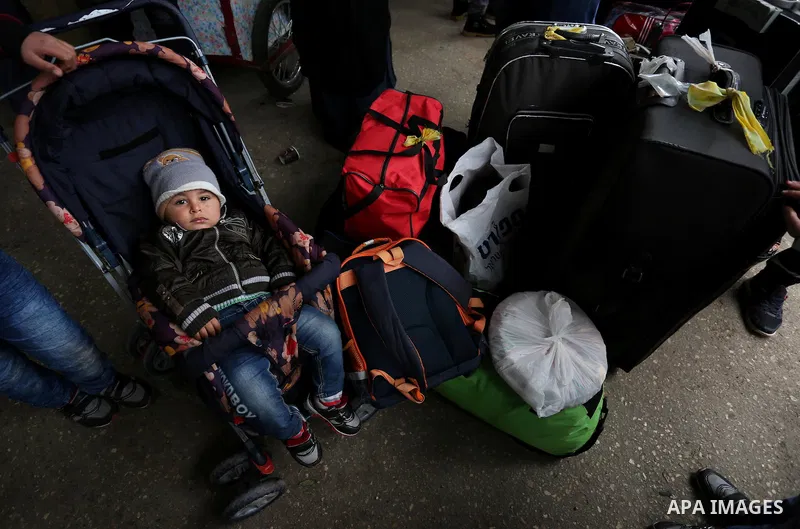 Palestinians wait for travel permits to cross into Egypt through the Rafah border crossing after it was opened by Egyptian authorities for humanitarian cases, in Rafah in the southern Gaza Strip on February 12, 2017. Pho...