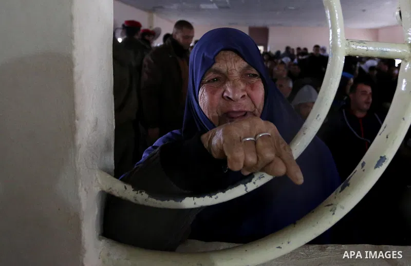 Palestinians wait for travel permits to cross into Egypt through the Rafah border crossing after it was opened by Egyptian authorities for humanitarian cases, in Rafah in the southern Gaza Strip on February 12, 2017. Pho...