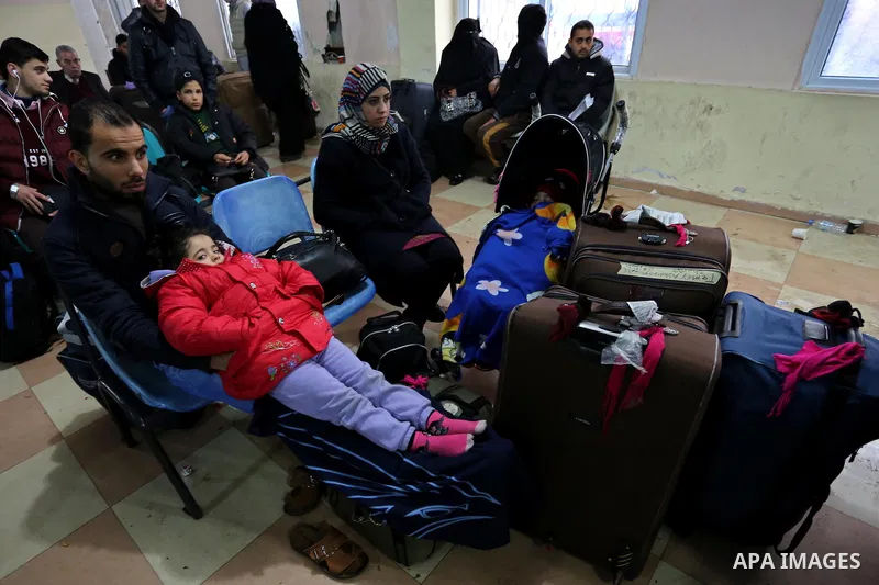 Palestinians wait for travel permits to cross into Egypt through the Rafah border crossing after it was opened by Egyptian authorities for humanitarian cases, in Rafah in the southern Gaza Strip on February 12, 2017. Pho...