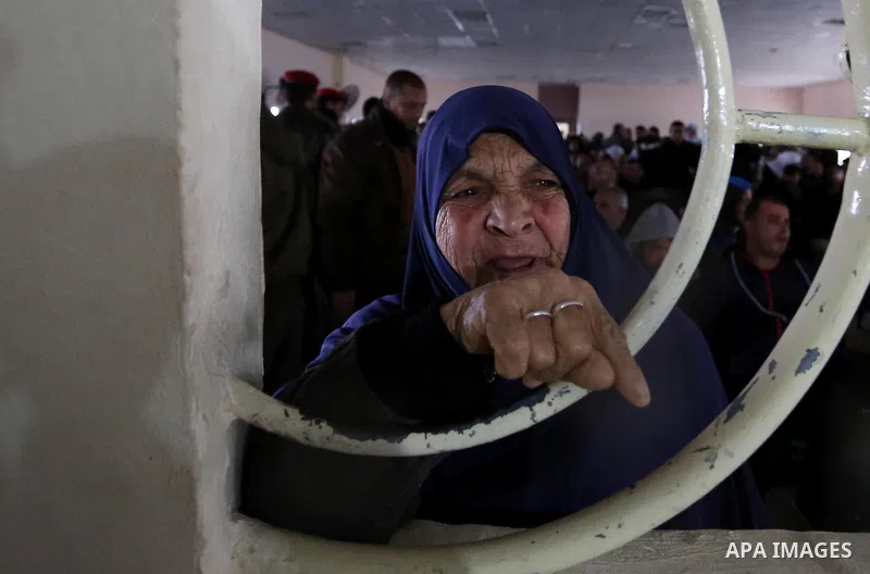A Palestinian woman reacts as she asks for a travel permit to cross into Egypt through the Rafah border crossing, after it was opened by Egyptian authorities for humanitarian cases, in Rafah in the southern Gaza Strip on...