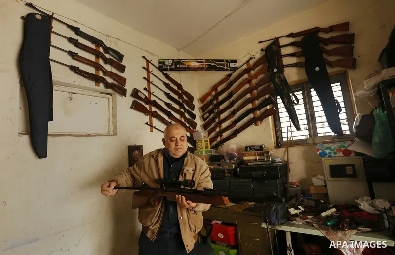 Khalil Taima, a 53-year-old Palestinian man, fixes the barrel of an air rifle used for target-shooting and hunting at his shop in the Nuseirat refugee camp in the central Gaza Strip on February 13, 2017. Photo by Ashraf...
