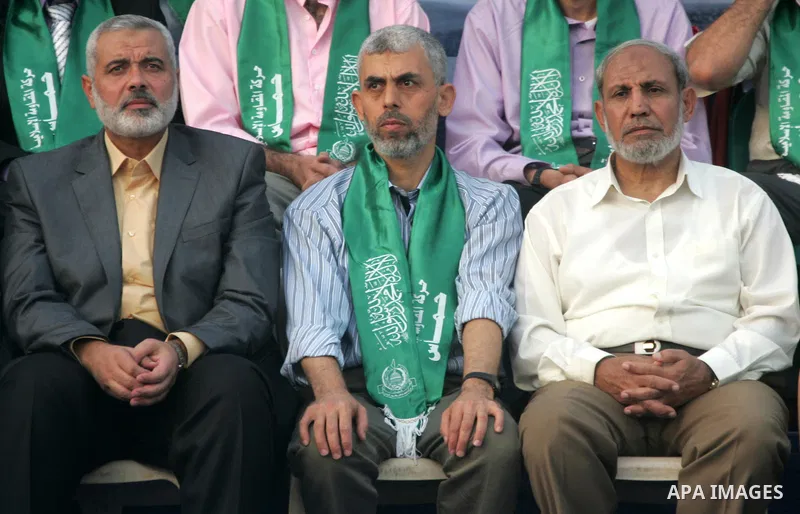 This file photo taken on October 21, 2011 shows then Hamas leader Ismail Haniya (L) and freed Palestinian prisoner Yahya Sinwar (C), and Senior Hamas leader Mahmoud al-Zahar (L), attend ceremony of the release of hundred...