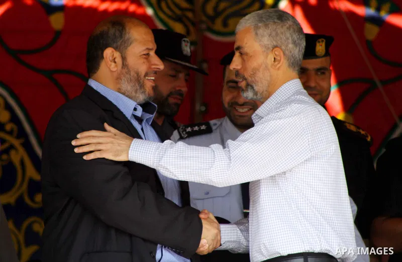 This file photo taken on October 27, 2011 shows then Palestinian Hamas leader Khaleel al-Heah shakes hands with freed prisoner Yahya Sinwar, in Gaza city. Palestinian Islamist movement Hamas elected Yahya Sinwar, a hardl...