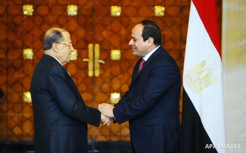 Egyptian President Abdel Fattah al-Sisi shakes hands with Lebanese President Michel Aoun during the a welcome ceremony at the Presidential palace in Cairo on February 13, 2017. Aoun started his first visit to Cairo since...