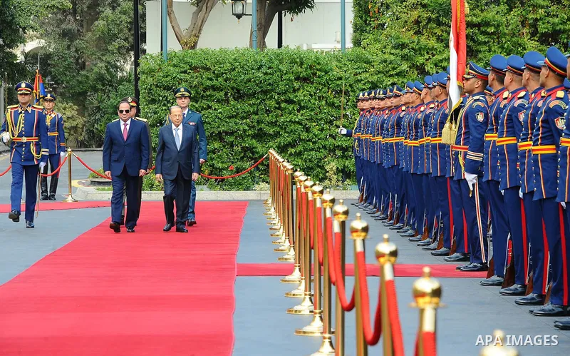 Egyptian President Abdel Fattah al-Sisi and Lebanese President Michel Aoun inspect the honor guards during the a welcome ceremony at the Presidential palace in Cairo on February 13, 2017. Aoun started his first visit to...