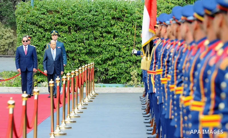Egyptian President Abdel Fattah al-Sisi and Lebanese President Michel Aoun inspect the honor guards during the a welcome ceremony at the Presidential palace in Cairo on February 13, 2017. Aoun started his first visit to...