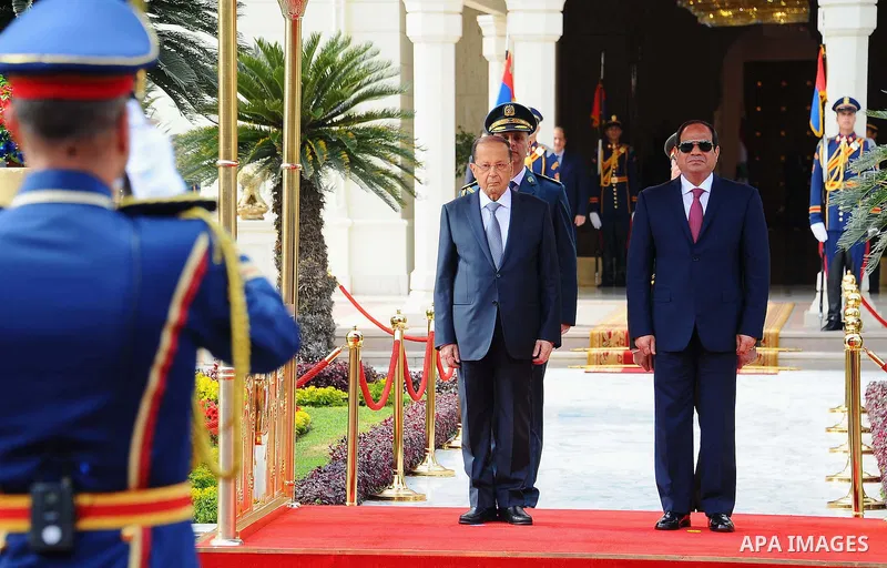 Egyptian President Abdel Fattah al-Sisi and Lebanese President Michel Aoun inspect the honor guards during the a welcome ceremony at the Presidential palace in Cairo on February 13, 2017. Aoun started his first visit to...