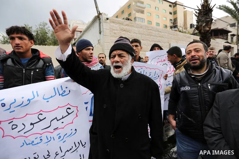Palestinian owners of factories hold banners during a protest demanding to reconstruction their factories which was destroyed during the 50-day war between Israel and Hamas militants in the summer of 2014, in Gaza city o...