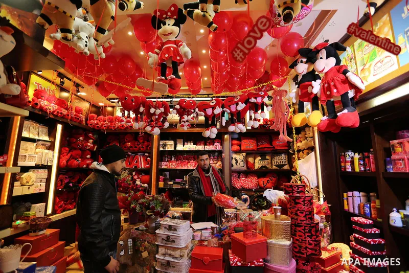 Palestinian vendors display flowers, red teddy bears, red ballons and pillows on Valentine's day in Gaza city on February 14, 2017. Valentine's Day is increasingly popular in the region as people have taken up the custom...