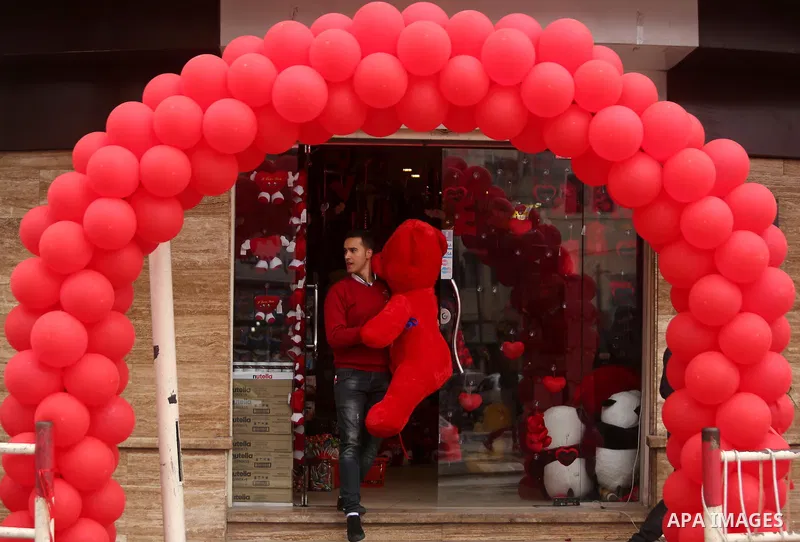 A Palestinian vendor carries teddy bear outside his shop on Valentine's day in Gaza city on February 14, 2017. Valentine's Day is increasingly popular in the region as people have taken up the custom of giving flowers, c...