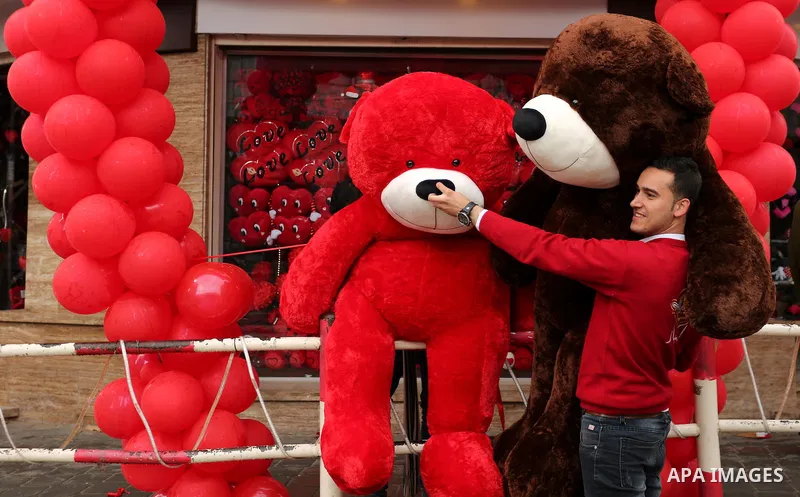 A Palestinian vendor carries teddy bear outside his shop on Valentine's day in Gaza city on February 14, 2017. Valentine's Day is increasingly popular in the region as people have taken up the custom of giving flowers, c...