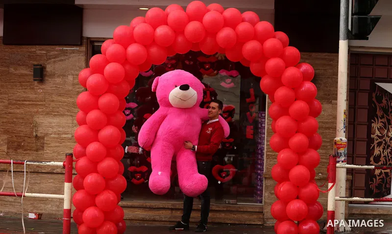 A Palestinian vendor carries a pink teddy bear outside his shop on Valentine's day in Gaza city on February 14, 2017. Valentine's Day is increasingly popular in the region as people have taken up the custom of giving flo...
