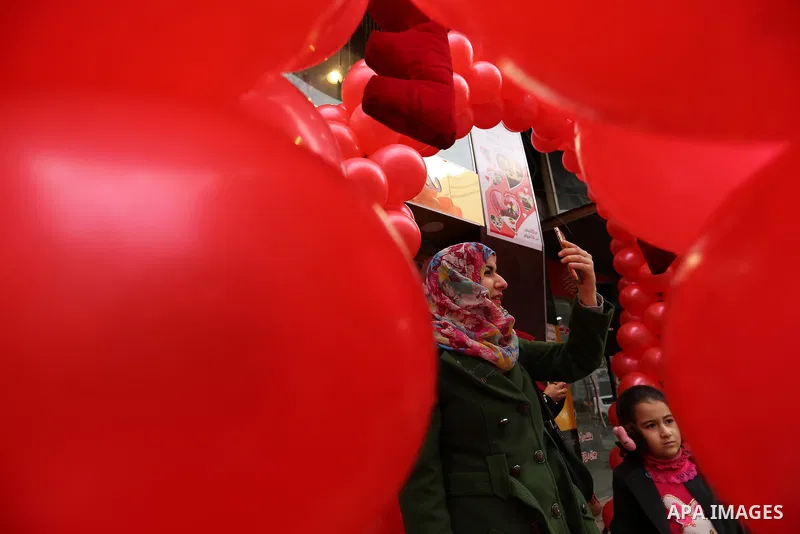 A Palestinian woman takes a selfie with red teddy bears outside a shop on Valentine's day in Gaza city on February 14, 2017. Valentine's Day is increasingly popular in the region as people have taken up the custom of giv...