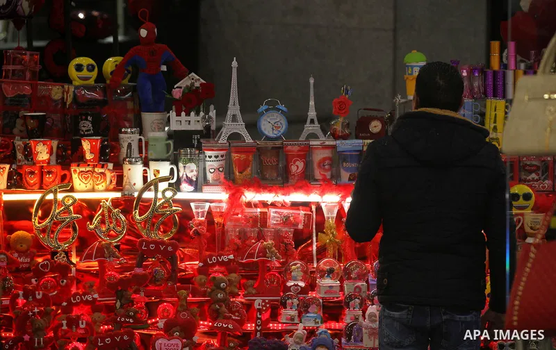 Palestinian vendors display red teddy bears, red ballons and pillows on Valentine's day in the West Bank city of Hebron on February 14, 2017. Valentine's Day is increasingly popular in the region as people have taken up...